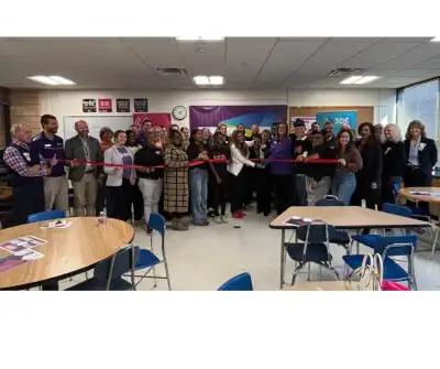 Image of a group of people cutting a ribbon